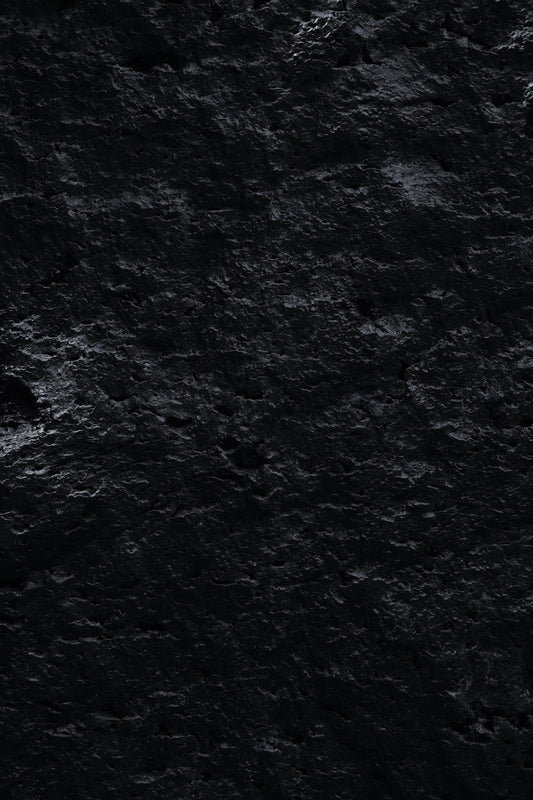 a black and white photo of rocks and water