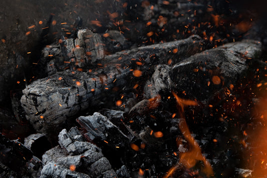 a close up of a pile of wood and fire