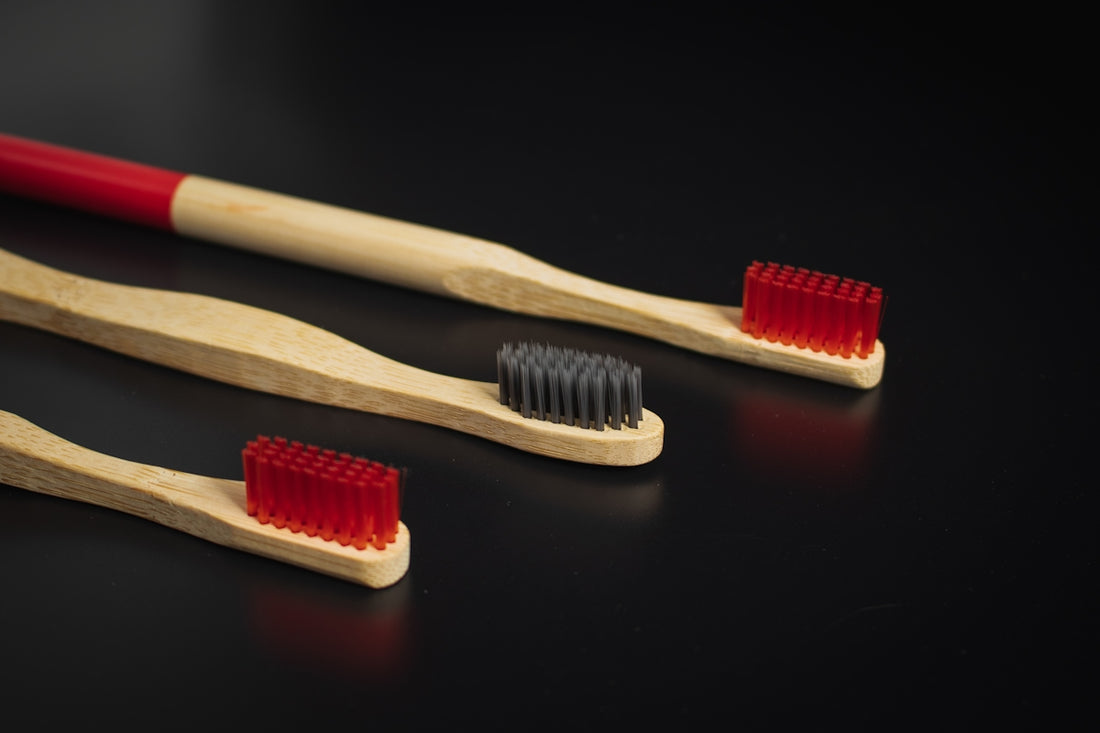 two toothbrushes sitting next to each other on a table