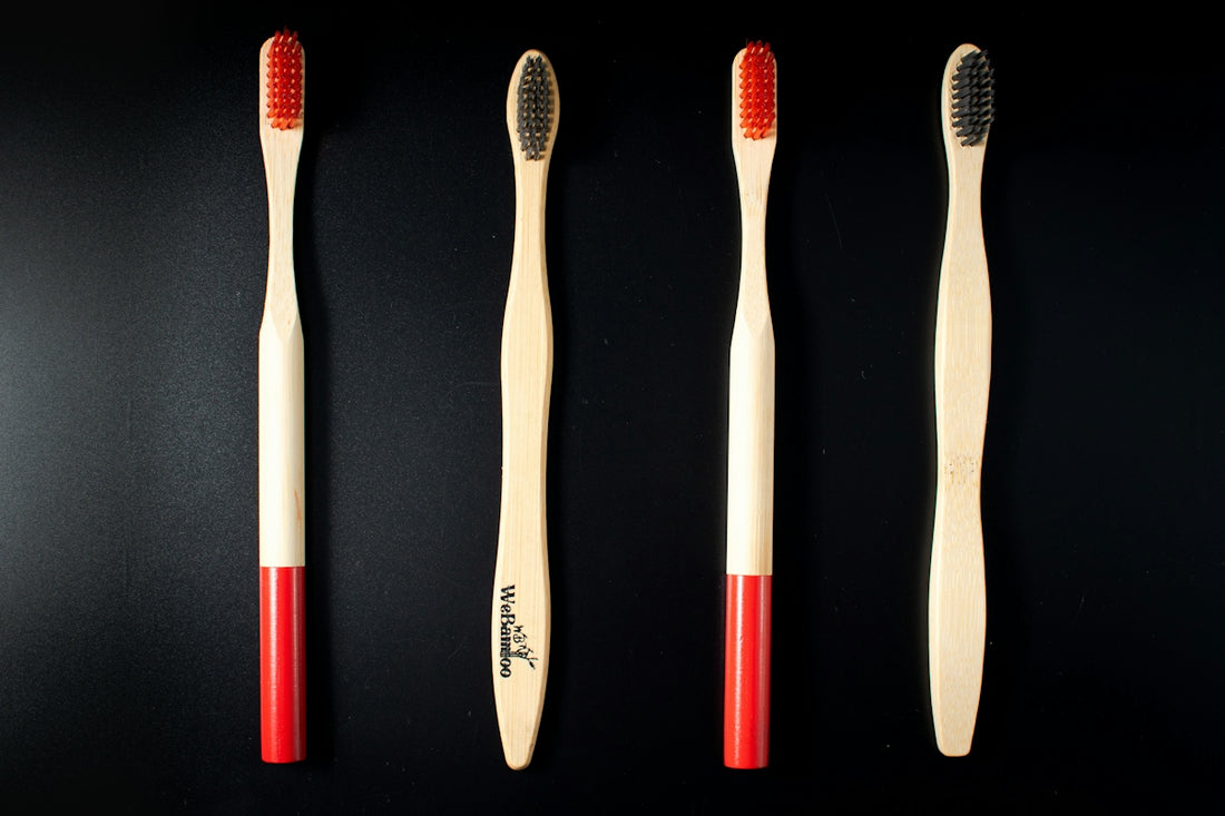 three toothbrushes lined up on a black surface