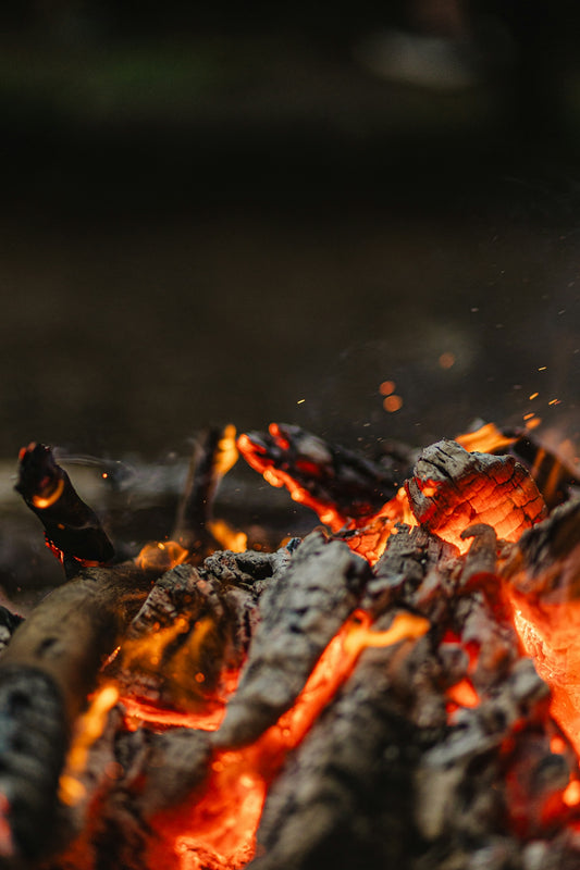 Glowing embers from a dying campfire